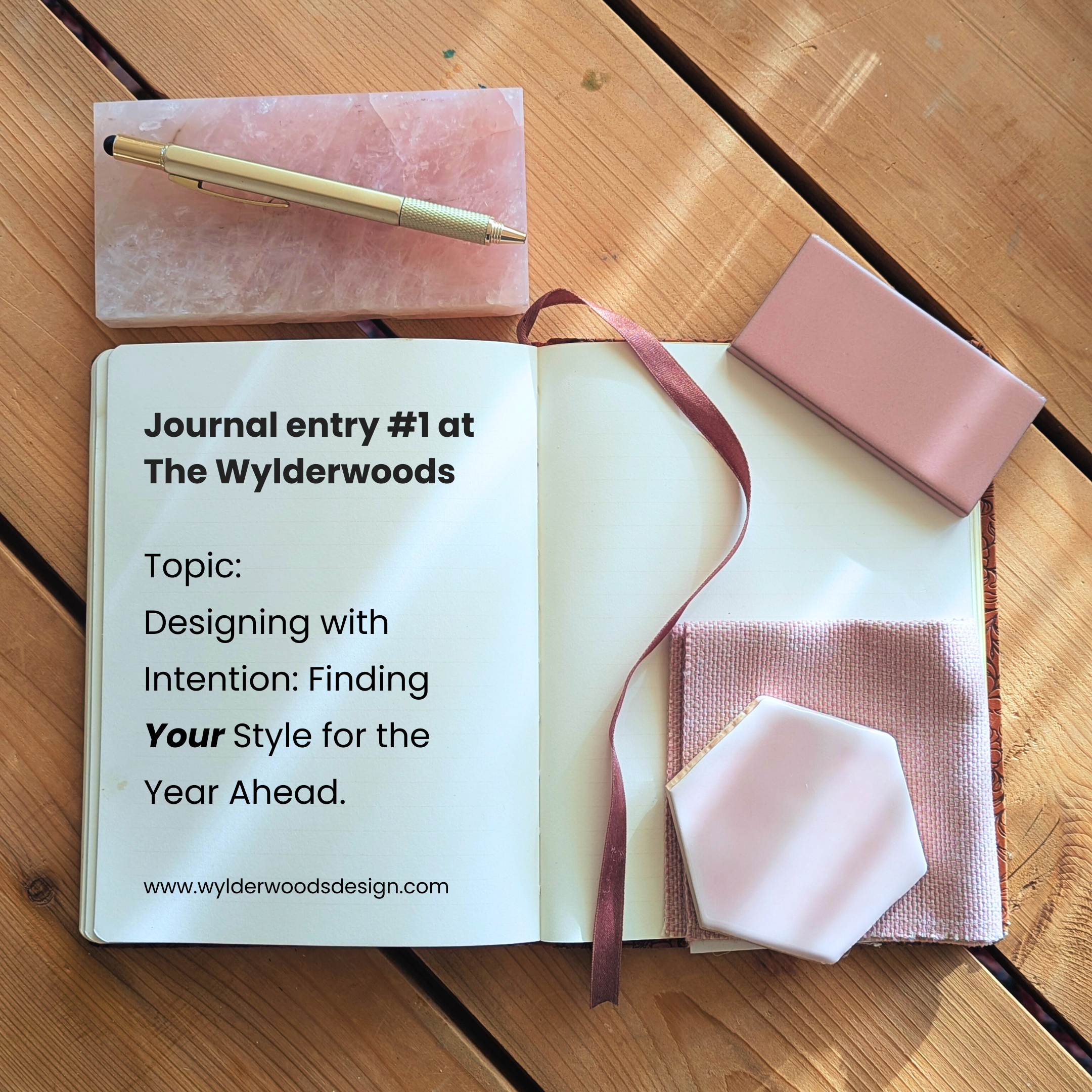 Flat lay of pink materials on a wooden background representing the concept of designing with intention and finding your style for the year ahead.